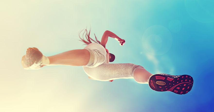 Woman running, blue sky above, picture from below