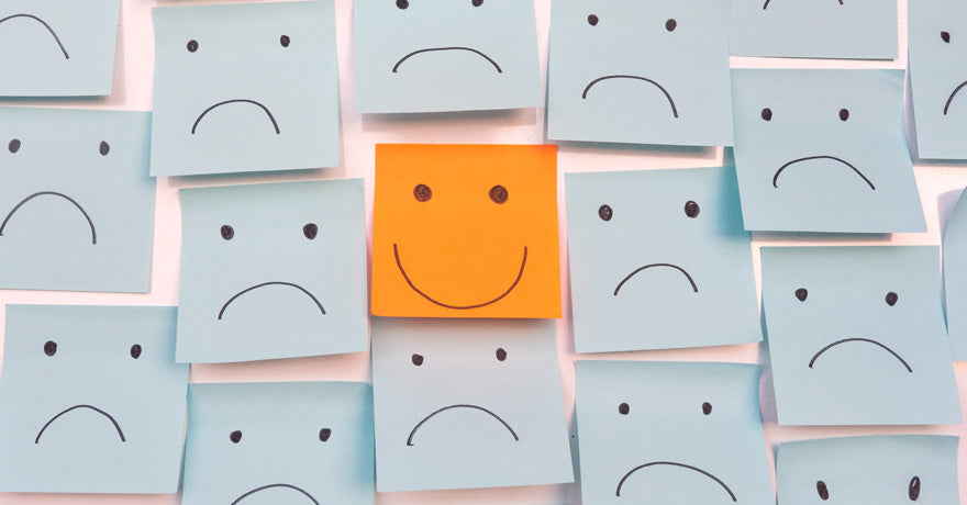 Frowning and smiley faces post it notes