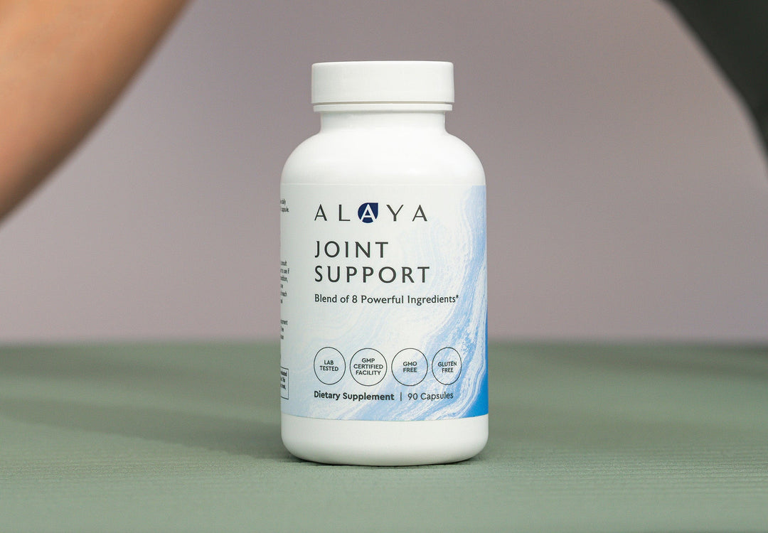 Alaya Joint Support supplement on a green mat