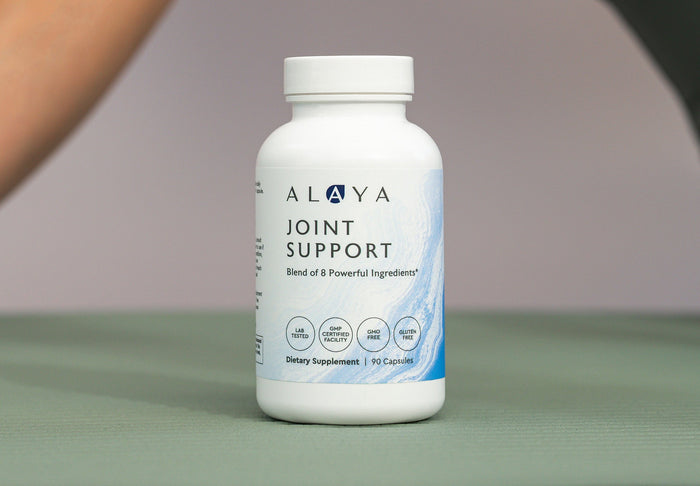Alaya Joint Support supplement on a green mat