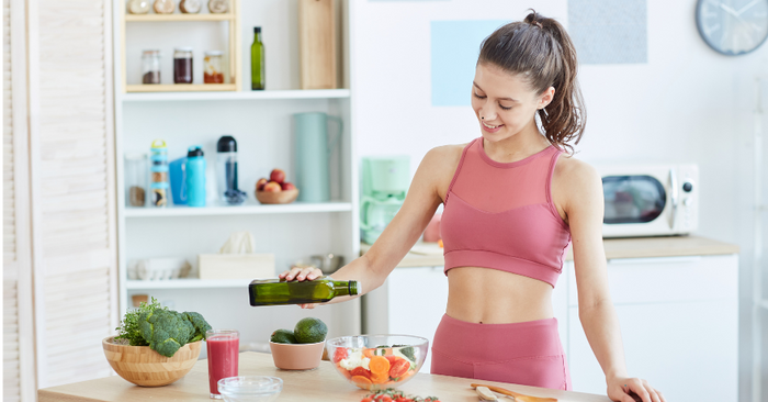woman making salad at kitchen counter