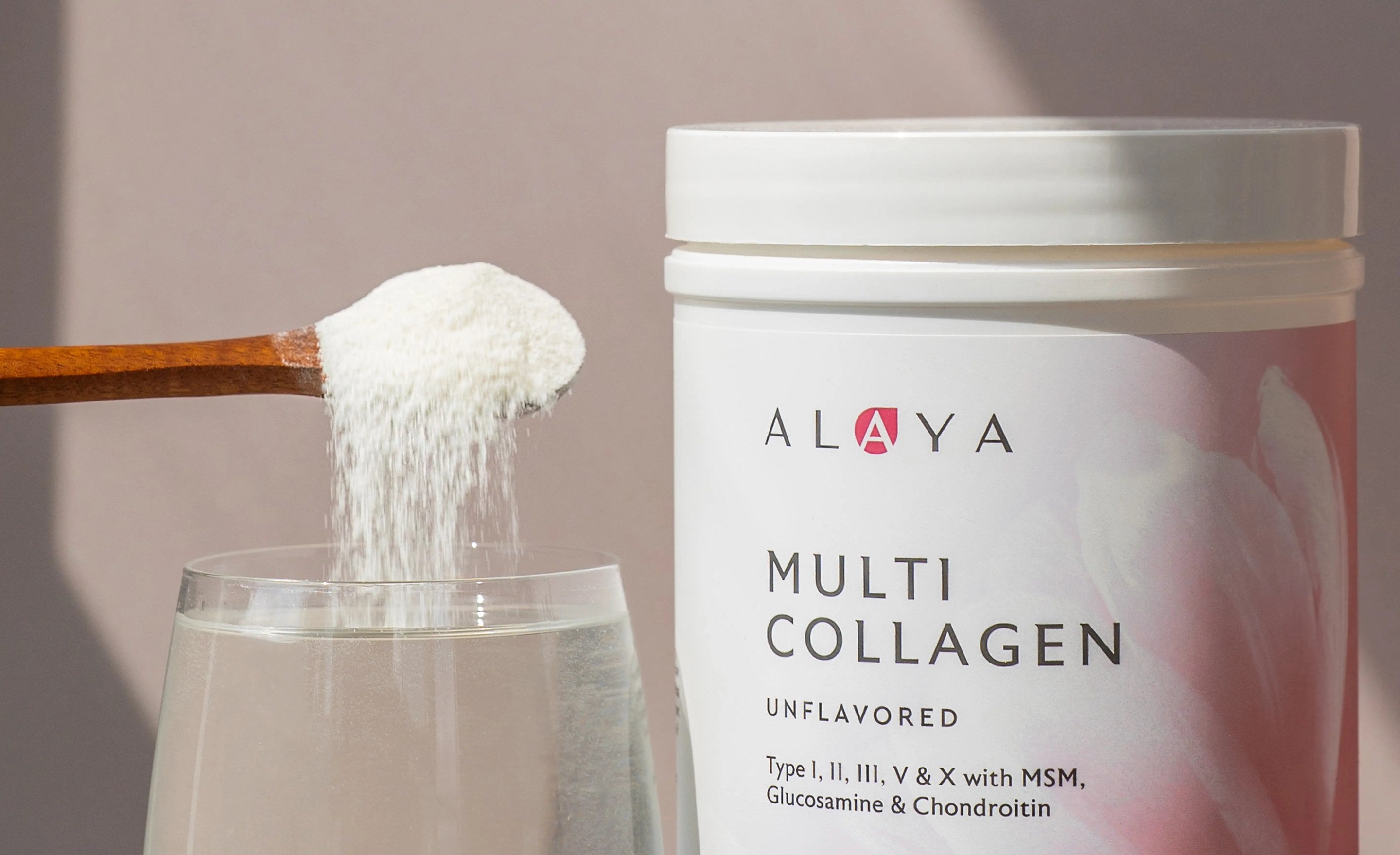 A scoop of Alaya Multi Collagen powder going into a glass